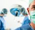 Doctor in scrubs in foreground with blurred people in scrubs in background during surgery possible medical malpractice
