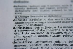 Close up photo of page in the dictionary with the focus on the word "definition"