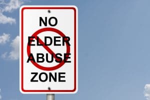 Road sign with no elder abuse zone written on it